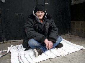 In this March 15, 2019, file photo, John Rollo, who lives on the street, sits on a handmade mat given to him by Rotary Club of Windsor 1918. Fashioned from hundreds of plastic bags, the mat is easy to clean and turns any spot into a place to sleep, said Rollo, shown here in the 300 block of Ouellette Avenue.