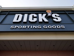FILE- This Feb. 28, 2018, file photo shows a Dick's Sporting Goods store in Arlington Heights, Ill. Dick's Sporting Goods Inc. said on Tuesday, March 12, 2019, that it will stop selling hunting rifles and ammunition at 125 of its stores, replacing the gear with merchandise it believes will sell better at those locations.