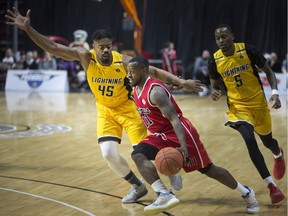 Windsor's Chris Jones drives past London's Marvin Phillips in NBLC action between the Windsor Express and the London Lightning at the WFCU Centre, Wednesday, March 13, 2019.