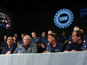 Sergio Marchionne, chairman and DEO, FCA US, Dennis Williams, president UAW, Norwood Jewell, vice president of the FCA US Department, UAW, and Glenn Shagena, vice president - employee relations FCA North America, (left to right) take part in a joint press conference to kick off the UAW-FCA labour talks at the UAW-Chrysler National Training Centre in Detroit on July 13, 2015.