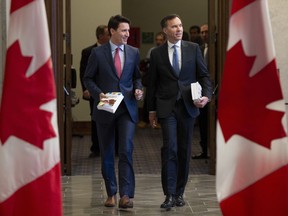 Prime Minister Justin Trudeau and Finance Minister Bill Morneau speak as they walk to the House of Commons in Ottawa on March 19, 2019.