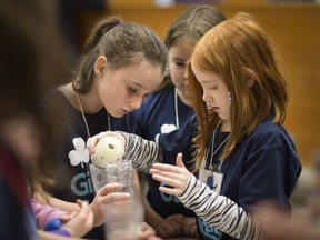 Summer Pettenato, Sarah Haney and Alice Leblanc (left to right) work on a water filtration system at Girl Guide Badge Day at the Ed Lumley Centre  for Engineering Innovation on March 16, 2019.  Nearly 80 Girl Guides from Windsor and Essex County earned engineering, science, and water badges by completing hands-on activities at the University.