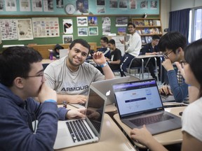 Students, from left, Nathan Levy, 15, Sandro Hakim, 18, Daniel Yun, 15, and Elisa Ward, 15, prepare to start hacking at the 5th annual Massey Hacks on March 24, 2019.  Nearly 200 student hackers participated in the 24-hour hackathon.