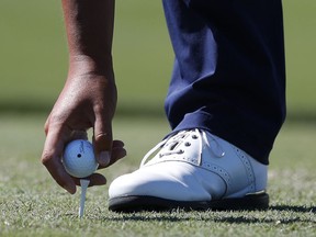 Kyong-Hoon Lee, of South Korea, places his ball before teeing off on the sixth hole during the third round of the Honda Classic golf tournament, Saturday, March 2, 2019, in Palm Beach Gardens, Fla.