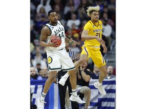 Michigan State forward Nick Ward grabs a rebound in front of Minnesota forward Jarvis Omersa, right, during a second round men's college basketball game in the NCAA Tournament, Saturday, March 23, 2019, in Des Moines, Iowa.