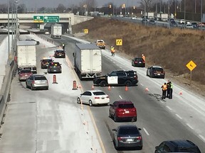 OPP investigate at the scene of a collision between a pedestrian and a transport truck on Highway 401 at Todd Lane on March 8, 2019.