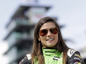 FILE - In this May 20, 2018, file photo, Danica Patrick waits during qualifications for the IndyCar Indianapolis 500 auto race at Indianapolis Motor Speedway in Indianapolis. Patrick, who retired from racing after last year's Indianapolis 500, will join NBC Sports' inaugural coverage of the Indianapolis 500 as a studio analyst alongside host Mike Tirico.