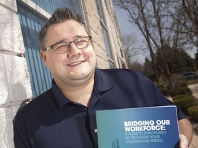 Jason Falconer, senior director of Workforce WindsorEssex, holds up the new guide book for jobs related to the Gordie Howe International Bridge, Wednesday, March 27, 2019.