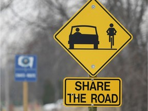 With the CWATS Route sign up ahead, a Share the Road sign alerts motorists to do just that along Old Tecumseh Road in Lakeshore on March 21, 2019.