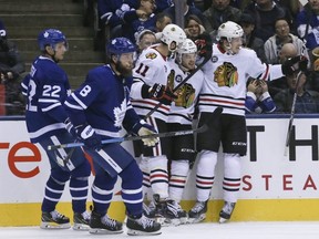 Blackhawks players celebrate a goal against the Maple Leafs in the second period during NHL action in Toronto on Wednesday, March 13, 2019.