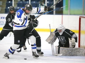 Cohen Kiteley, of the London Nationals, is tied up in front of  LaSalle Vipers goalie Will Tragge by defenceman Gianluca Pizzuto during Wednesday's playoff game at Western Fair Sports Centre.