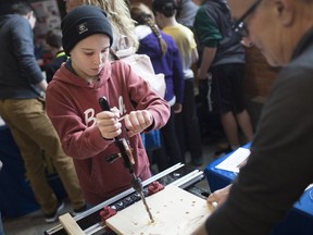 Nash Renaud, 12, tries out an old style hand drill while at the 2nd annual Windsor-Essex Maker Faire at the University of Windsor's School of Creative Arts on March 24, 2019.