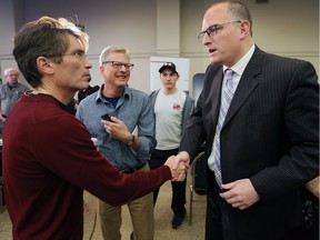 In this Oct. 22, 2018, election night file photo, Matt Marchand, left, congratulates re-elected Windsor Mayor Drew Dilkens at the St. Clair Centre for the Arts after his re-election.