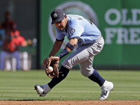Seattle Mariners second baseman Kristopher Negron misplays a ground ball from Los Angeles Angels' Tommy La Stella for an error in the second inning of a spring training baseball game on March 10, 2019, in Tempe, Ariz.