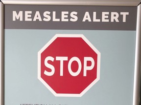 File - In this Jan. 30, 2019, file photo, a sign posted at The Vancouver Clinic in Vancouver, Wash., warns patients and visitors of a measles outbreak.
