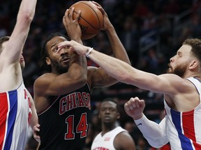 Chicago Bulls guard Wayne Selden (14) looks to shoot as Detroit Pistons forwards Jon Leuer, left, and Blake Griffin (23) defend during the first half of an NBA basketball game Sunday, March 10, 2019, in Detroit.