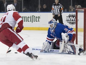 New York Rangers goaltender Henrik Lundqvist (30) makes the save against Detroit Red Wings center Dylan Larkin (71) during the first period of an NHL hockey game, Tuesday, March 19, 2019, at Madison Square Garden in New York.