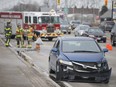 A damaged car sits on the side of the road after rear-ending a transport truck on Huron Church Rd., between Industrial Dr. and E.C. Row Expressway, Wednesday, March 13, 2019.  No injuries were reported but lanes were reduced to one lane causing major traffic backups along Huron Church Rd.