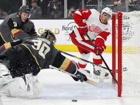 Detroit Red Wings center Andreas Athanasiou, right, passes around Vegas Golden Knights goaltender Malcolm Subban for an assist during the first period of an NHL hockey game Saturday, March 23, 2019, in Las Vegas.