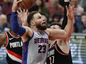 Detroit Pistons forward Blake Griffin, left, shoots as Portland Trail Blazers center Jusuf Nurkic defends during the first half of an NBA basketball game in Portland, Ore., Saturday, March 23, 2019.