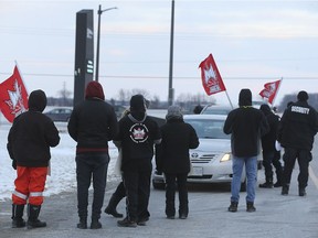 Part-time striking workers at the Atlas Tube Centre in Lakeshore briefly hold up traffic entering the facility on Wednesday, March 6, 2019. They are members of IBEW Local 636.