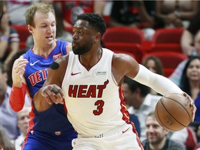 Miami Heat guard Dwyane Wade (3) drives against Detroit Pistons guard Luke Kennard during the first half of an NBA basketball game, Wednesday, March 13, 2019, in Miami.