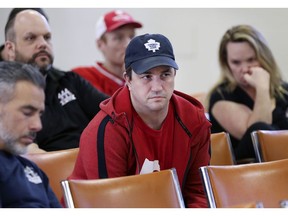 Bad news. Autoworker Brad Chyz, centre, and fellow employees of FCA Canada's Windsor Assembly Plant listen on March 29, 2019, as Navdeep Bains, federal Minister of Innovation, Science and Economic Development, speaks at the Unifor Local 444 hall on Turner Road.
