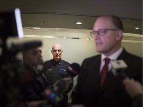 Windsor Police Service Chief Al Frederick, listens in as Mayor Drew Dilkens, the police board's chairman, speaks to the media following a board meeting on March 1, 2019.