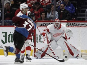 Colorado Avalanche left wing J.T. Compher scores a goal against Detroit Red Wings goaltender Jonathan Bernier during the second period of an NHL hockey game in Denver on March 5, 2019.