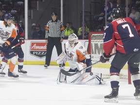 Windsor Spitfires centre Tyler Angle looks on as the puck goes by Flint goaltender, Emmanuel Vella during Thursday's OHL game at the WFCU Centre.