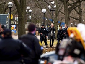 University of Michigan police officers respond with Washtenaw County Sheriff's deputies and the FBI, ATF and U.S. Border Patrol to a report of an active shooter on the University of Michigan campus near Mason Hall in Ann Arbor, Mich., Saturday, March 16, 2019.