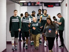 Michigan State guard Matt McQuaid, left, guard Cassius Winston, forward Aaron Henry, forward Xavier Tillman and forward Kenny Goins walk to an NCAA men's college basketball individual news conferences in Washington, Saturday, March 30, 2019. Michigan State plays Duke in the East Regional final game on Sunday.