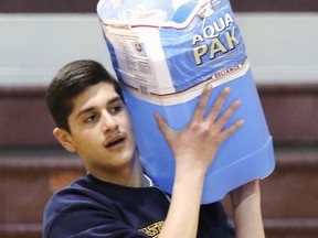 Catholic Central High School students held a special event on Friday to recognize World Water Day. The United Nations has declared March 22 as World Water Day, an opportunity to draw attention to the fact that access to clean, safe water is a basic human right and that more needs to be done to protect that right. Bahjat Mezka, 14, carries a large container of water during the event.