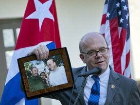 U.S. Democratic congressman for the state of Massachusetts and House Rules Committee Chairman Rep. Jim McGovern holds up a framed archival image that shows him and Fidel Castro, during the inauguration of a conservation center in Havana, Cuba, Saturday, March 30, 2019. U.S. and Cuban conservators opened a conservation center at Finca Vigia, Ernest Hemingway's Havana home.