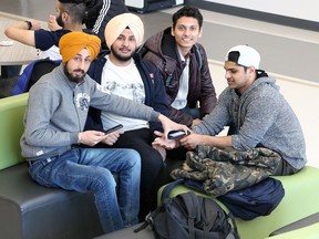 St. Clair College international students from India, Harnek Singh, left, Varun Jot Singh, Nitish Trikha and Sunil Kumar, right, chat before classes at the Zekelman School of Business Wednesday.