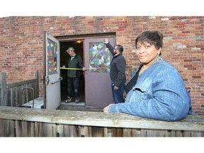 An appreciative Lana Talbot, right, of Sandwich First Baptist Church, watches as door specialist with Sentry Windows and Doors by Brookstone Home Exteriors, size up the rear door of the historic Sandwich church where slaves from the United States took refuge after fleeing into Canada.  Many slaves were hidden under the floors to keep away from bounty hunters. Sandwich First Baptist Church is located at 3652 Peter Street.