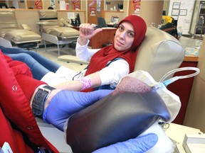 Najwa Taleb of Windsor's Enterprise Skills Training (WEST) gives a thumbs up after donating a unit of blood during the 2nd annual Give Back to the Community Donation Day at Canadian Blood Services on Grand Marais Road East.  The initiative allows the newcomers to our community to volunteer to contribute something significant to Canadian society.  Windsor's 2nd annual Blood Donation Day event, hosted by, Canadian Blood Services, Windsor Women Working with Immigrant Women, YMCA, WEST, MCC, Unemployed Help Centre at Canadian Blood Services Windsor.