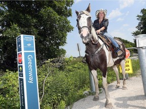 Tanya Harrison and her Tennessee Walker 'Southern' at the Greenway Trail opening on Hyland Side Road.  Harrison has started a petition to allow horseback riders on the Greenway trail system July 10, 2018.