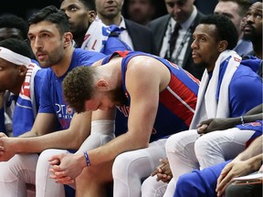 Blake Griffin of the Detroit Pistons sits on the bench between teammates Zaza Pachulia and Ish Smith after fouling out against the Milwaukee Bucks during the second half of Game Four of the first round of the 2019 NBA Eastern Conference Playoffs at Little Caesars Arena on April 22, 2019 in Detroit, Michigan. The Bucks defeated the Pistons in four straight games, 127-104.