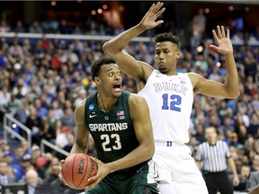 Xavier Tillman of the Michigan State Spartans is defended by Javin DeLaurier of the Duke Blue Devils during the second half in the East Regional game of the 2019 NCAA Men's Basketball Tournament at Capital One Arena on March 31, 2019 in Washington, DC.