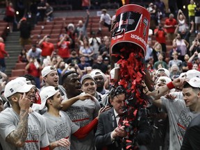 Texas Tech players shower coach Chris Beard with confetti after their win against Gonzaga during the West Regional final in the NCAA men's college basketball tournament Saturday, March 30, 2019, in Anaheim, Calif. Texas Tech won 75-69.