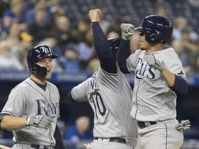 Tampa Bay Rays' Willy Adames, right, celebrates with teammates after hitting two run home run against the Toronto Blue Jays in the ninth inning of their American League MLB baseball game in Toronto, April 12, 2019.