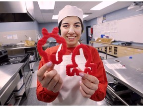 L'Essor Secondary student Mikaila Nouhra displays 3D printed cookie cutters at the school on Wednesday, April 3, 2019. The school's robotics team with cooking teacher Monique Pouget created a new cookbook that teaches kids and parents that science, technology, engineering and math are connected to almost everything we do.
