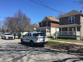 Windsor police investigators speak with a neighbourhood resident in the 3400 block of Cross Street on April 15, 2019. A residence at 3417 Cross St. is being searched in connection with the disappearance of Jerome Allen, 29.