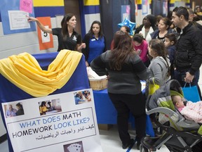 Cassia Hebert, a numeracy teacher at the Catholic School Board, helps parents understand the transition from addition to multiplication, during a Ministry-funded initiative called Building Parent Engagement: A Project to Support Ontario's Renewed Mathematics Strategy, at Immaculate Conception Catholic Elementary School on April 11, 2019.