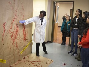 Amina Adama, a 4th-year Forensic Science student at the University of Windsor, explains blood spatter analysis at the annual Forensic Sciences Conference at the University of Windsor, Tuesday, April 2, 2019.