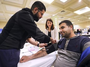 Over 900 people attended the Multicultural Council of Windsor and Essex County's 17th Annual Health Access Day on Wednesday, April 10, 2019, at the Fogolar Furlan Club in Windsor, ON. A total of 50 agencies and organizations were on hand to highlight nutrition, sports and fitness, mental health, social involvement, and medical treatment services. Omer Al-Shamari, left, with VON Canada takes Rustem Suleyman's blood pressure as Christine Frangione from the Multicultural organization looks own during the event.
