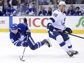 Toronto's Mitch Marner is tripped by Tampa Bay Lightning defenceman Mikhail Sergachev during second period NHL hockey action in Toronto on Thursday, April 4, 2019.