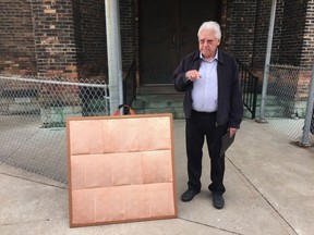 Paul Mullins displays a copper roof section during a press conference at Assumption Church on Thursday, April 18, 2019.