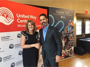 United Way Centraide CEO Lorraine Goddard on Thursday congratulates Sal Albano, an investment advisor at BMO Nesbitt Burns, who was one of eight honourees at the agency's Meet the Believers luncheon held at Essex Golf and Country Club.
